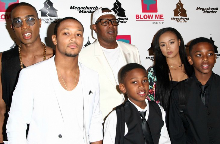 Veno Miller in a black t-shirt with his siblings in black and white dresses.